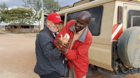 Foster is pictured here on the left with a Maasi Warrior Chief who is putting a bracelet on Foster as a gift. They’re in the Narok District in Kenya, Africa, one of the areas where Operation Eyesight works.