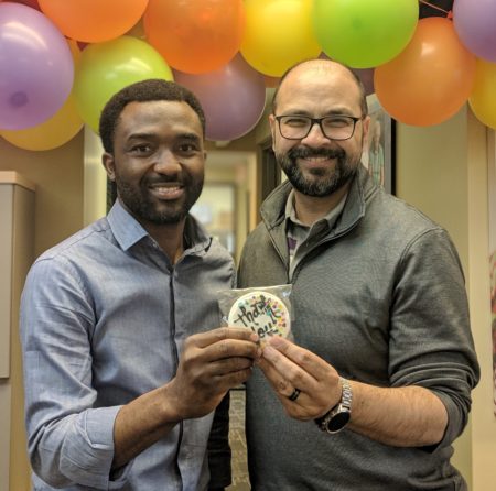 Our volunteer Sola being presented with a thank you cookie by Aly, President and CEO