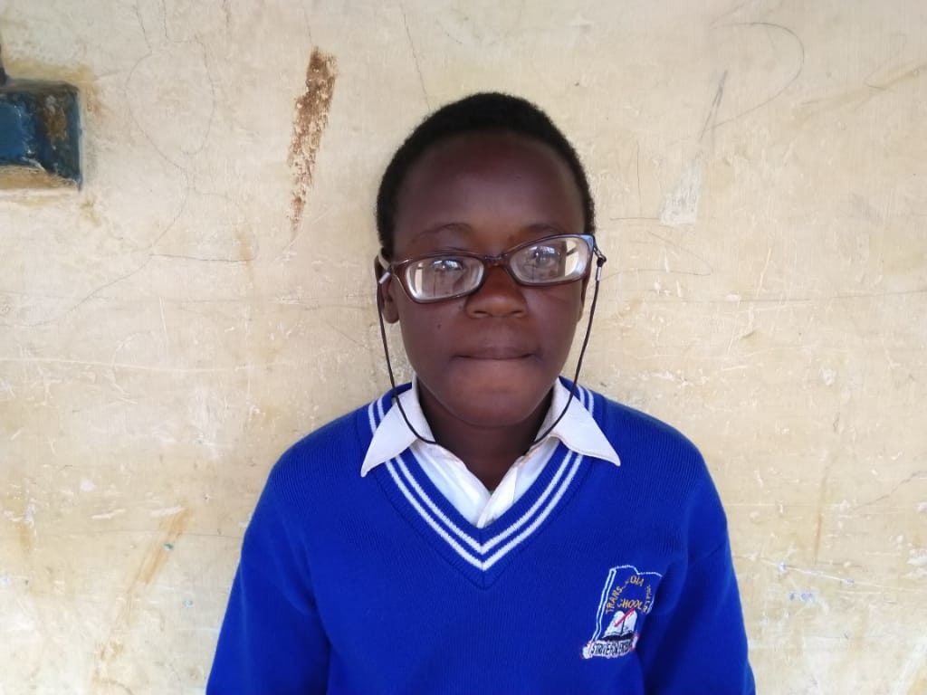 Hellen with her eyeglasses, looking at the camera