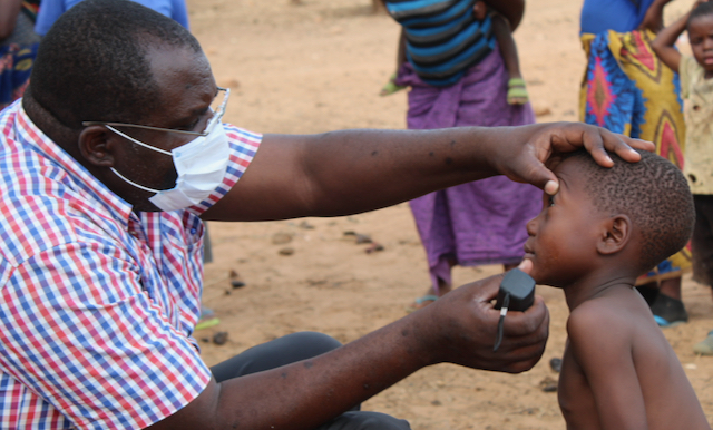 A man looks into the eyes of a little boy