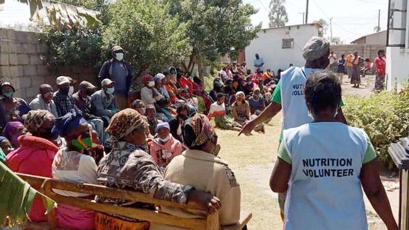 A community gathered together to hear from nutrition volunteers