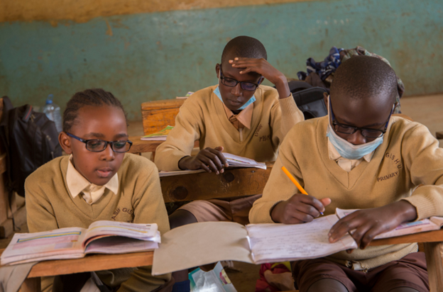 students, wearing eyeglasses, reads their textbooks